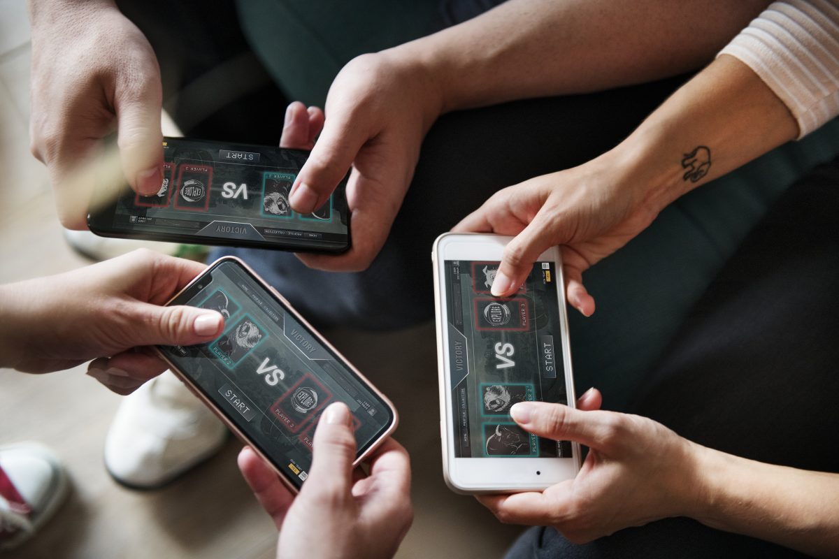 group-of-diverse-friends-playing-game-on-mobile-PAV3QXK-1200x800